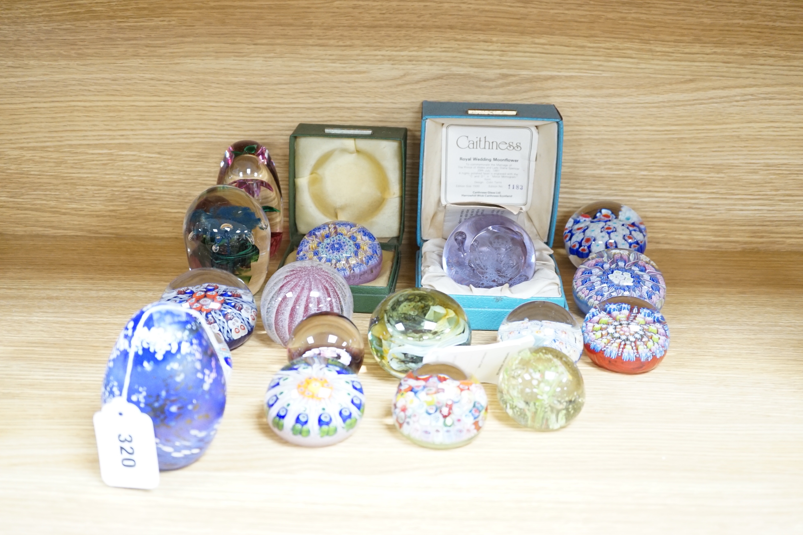 A collection of coloured glass paperweights including Strathearn, Caithness (28)